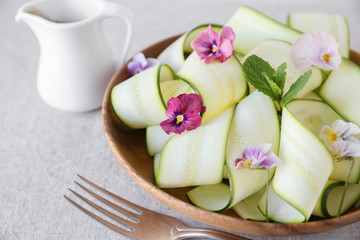 Zucchini salad with edible flowers, summer vegan salad
