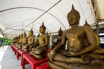 Row of golden Buddha statues at Champa temple,Taling Chan,Bangkok,Thailand