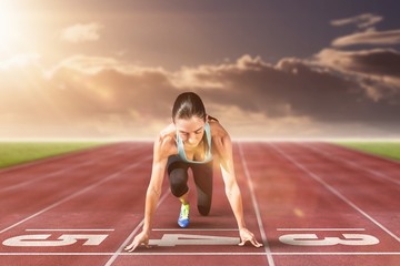 Composite image of sportswoman in the starting block