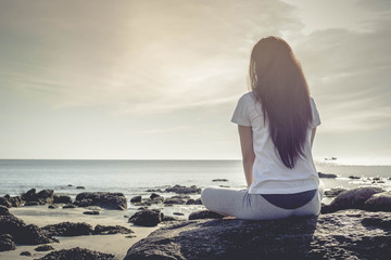meditating woman at beach