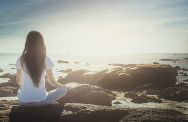 meditating woman at beach