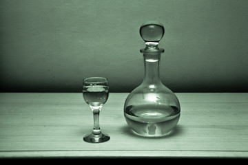 Still Life glass, decanter. On the table is a transparent composition consisting of a carafe of...