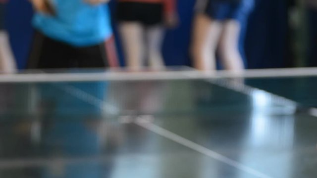 Young men playing table tennis. Competitions students in the gym.