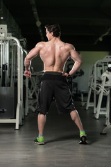 Obraz na płótnie Canvas Muscular Man Flexing Back Muscles Pose