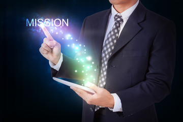 Businessman holding tablet with pressing mission. internet and networking concept