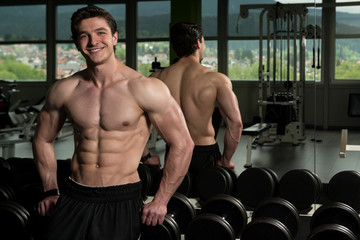 Fototapeta na wymiar Healthy Young Man Flexing Muscles