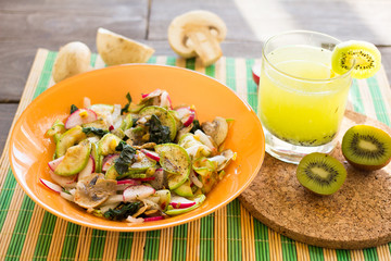 Vegetable warm salad with zucchini, mushrooms and radishes
