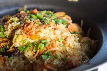 Thai crab fried rice on white dish with cucumbers