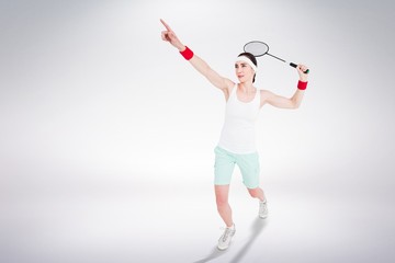Composite image of female athlete playing badminton 