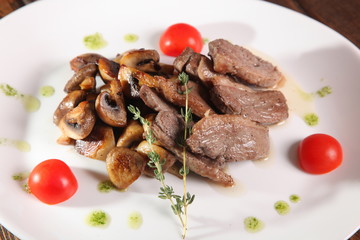 pieces of meat with mushrooms and pesto