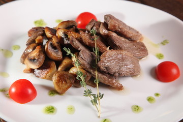 pieces of meat with mushrooms and pesto