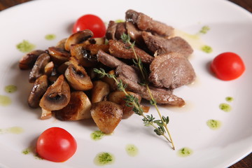 pieces of meat with mushrooms and pesto