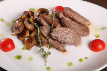 pieces of meat with mushrooms and pesto