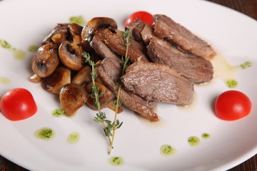 pieces of meat with mushrooms and pesto
