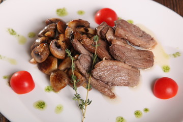 pieces of meat with mushrooms and pesto