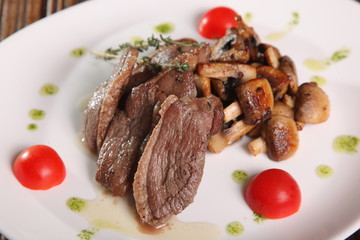 pieces of meat with mushrooms and pesto