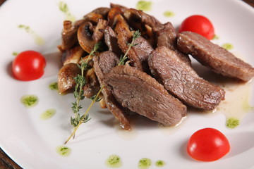 pieces of meat with mushrooms and pesto
