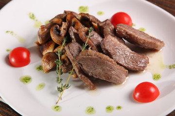 pieces of meat with mushrooms and pesto