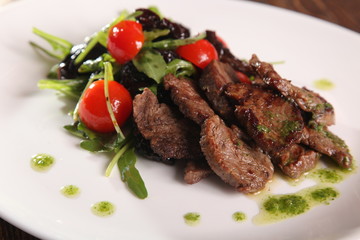 juicy meat with pesto and salad