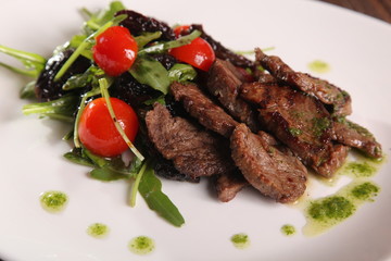 juicy meat with pesto and salad