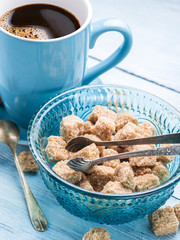 Cup of coffee and cane sugar cubes.
