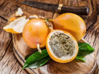 Granadilla fruits on the wooden table.