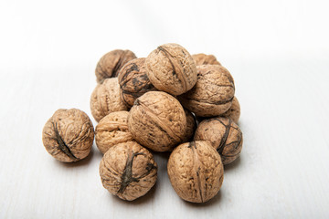 Heap of walnuts on white table