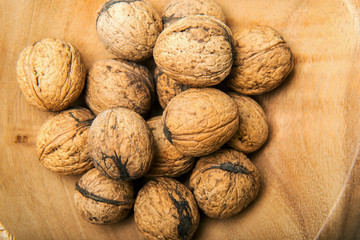 Heap of walnuts in wooden bowl