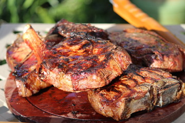 Char-grilled beef variety on a wooden plate