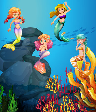 Mermaids swimming under the ocean