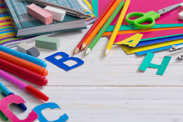 Back to school composition on white wooden background