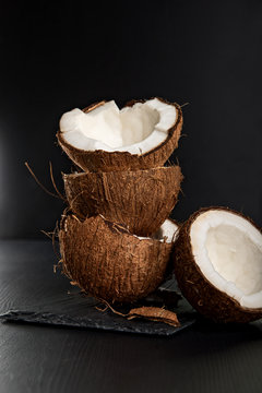 Stack of coconut shells on dark background
