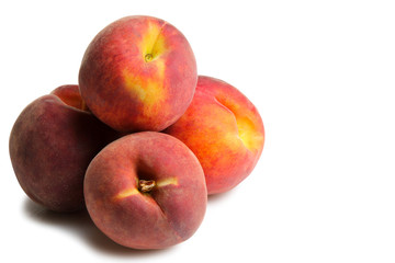 a bunch of delicious and juicy peaches on a white isolated background