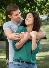 Obraz premium Romantic couple posing in city park, summer season, lovers boy and girl