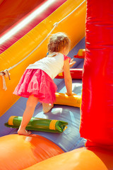 Fototapeta na wymiar child on a colorful trampoline