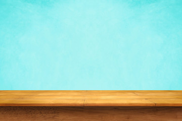 Empty top of wooden table on blue background.