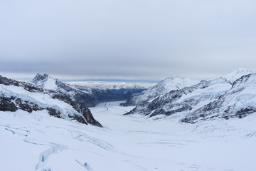 Fototapeta na wymiar snow scene on alpes mountains in cloud sky
