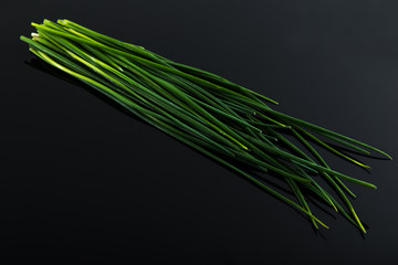Fresh green chives on dark board