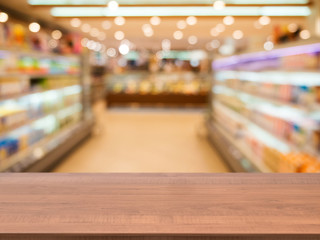 Wooden empty table in front of blurred supermarket