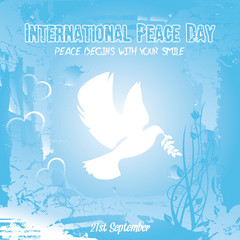 Peace dove with olive branch for International Peace Day poster on a blue grungy effect