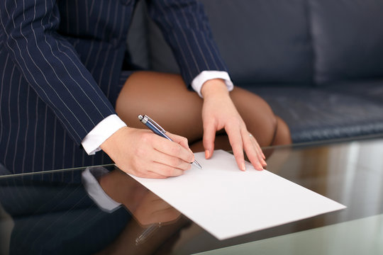 Businesswoman sign blank paper in formal wear