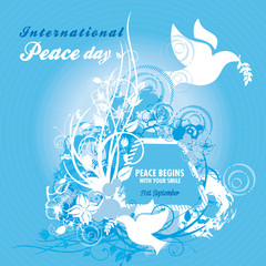 Two doves carrying an olive branch with elaborate floral designs for International Peace Day