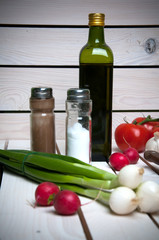 Vegetables, spices and olive oil on wooden background