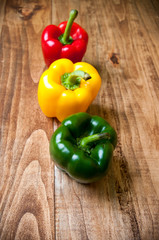 Red, yellow and green pepper on a table