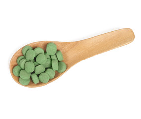 Herbal pill on wooden spoon. herb for healthy living.