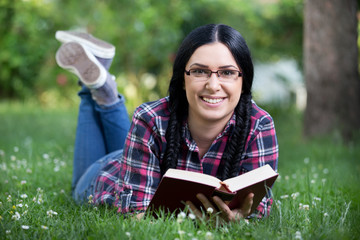 Girl reading book in park