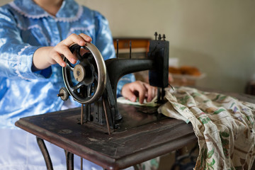 Woman and old sewing machine