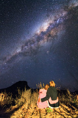 Romantic couple looking at the stars and the milky way at night in Madagascar