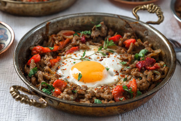 Fried egg with mince meat in traditional turkish pan