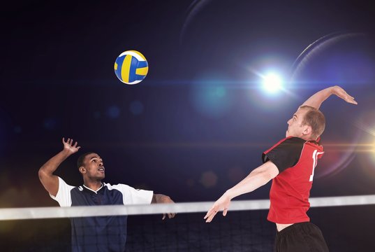 Composite image of sportsman hitting volleyball